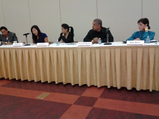 Summit Panel Presenters Addressing Audience